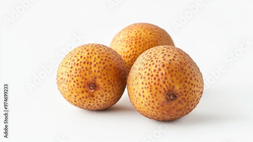 Three round, textured fruits with a yellow-brown hue arranged on a white background.