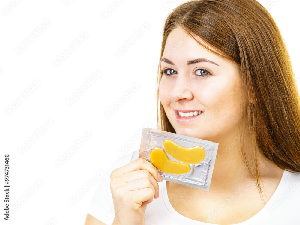 Woman ready to apply gold eye patches