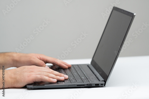 Male hands using laptop close up