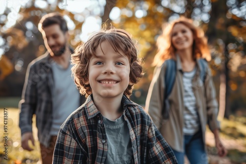 Portrait of a child with autism walking with their parents in a park,