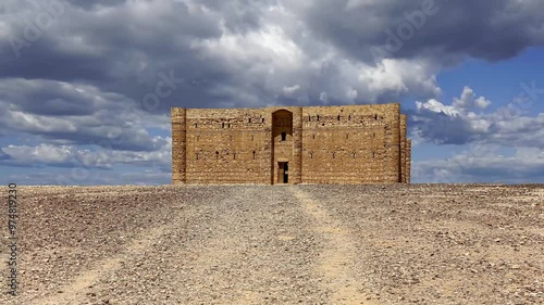 Qasr Kharana (Kharanah or Harrana)-- desert castle in eastern Jordan (100 km of Amman). Built in 8th century AD to be used as caravanserai. Against the sky with clouds. 4K, time lapse, zoom   photo