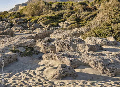 Eroded limestone rocks on a sandy beach