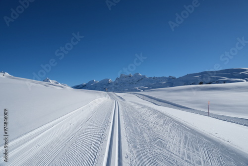 Photography Prepared cross country skiing track or piste in Switzerland on a sunny blue sky winter day