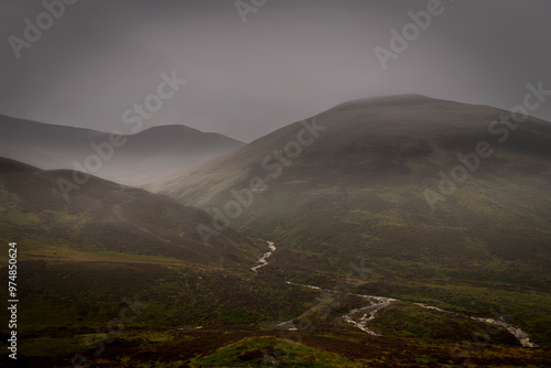 A dreich, misty, summer HDR image of the Glenshee area with rain falling and Creag Leacach in the background, Perthshire, Scotland photo