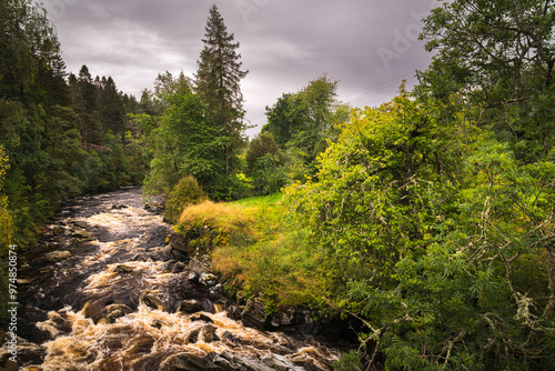A dull, summer HDR image of the River Feshie and some autumnal colour taken from the bridge at Feshiebridge, Badenoch, Scotland