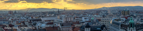 aerial panoramical view of western part of Vienna austrian capital city during golden hour sunset