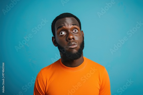 A man with a beard and dreadlocks is wearing an orange shirt, generative ai image