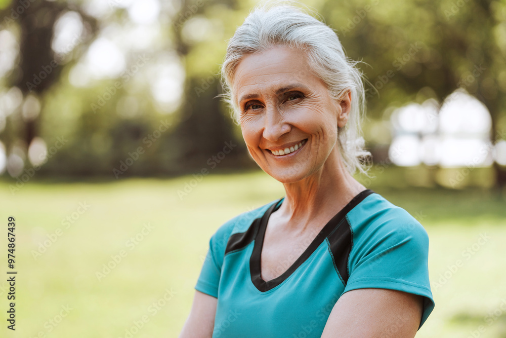Smiling senior woman smiling while relaxing after exercising outdoors Smiling senior woman smiling while relaxing after exercising outdoors