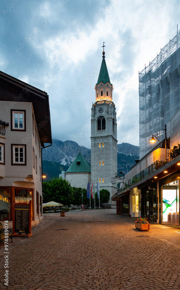 A view of the iconic church tower in the heart of Cortina d'Ampezzo. The architectural beauty of the tower stands tall against the backdrop of the surrounding Alpine scenery