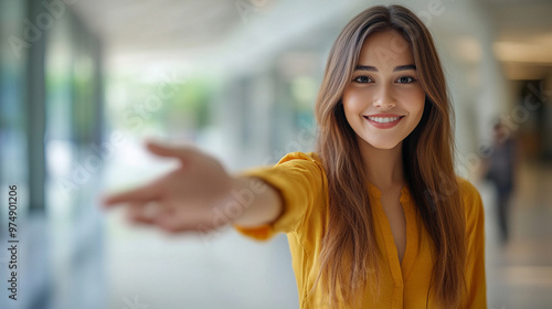 A professional HR recruiter reaches out with an inviting handshake, symbolizing new opportunities, trust, and a welcoming work environment. The background is blurred, emphasizing the gesture of connec