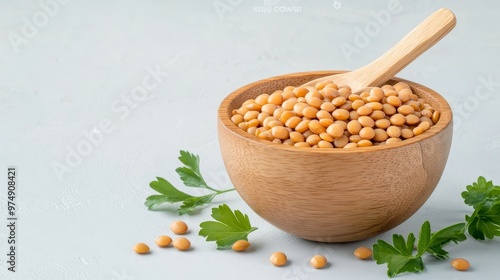 A wooden bowl filled with cooked brown lentils, a healthy and delicious vegan protein source.  The bowl is accompanied by fresh parsley, symbolizing the versatility and freshness of this legume. photo