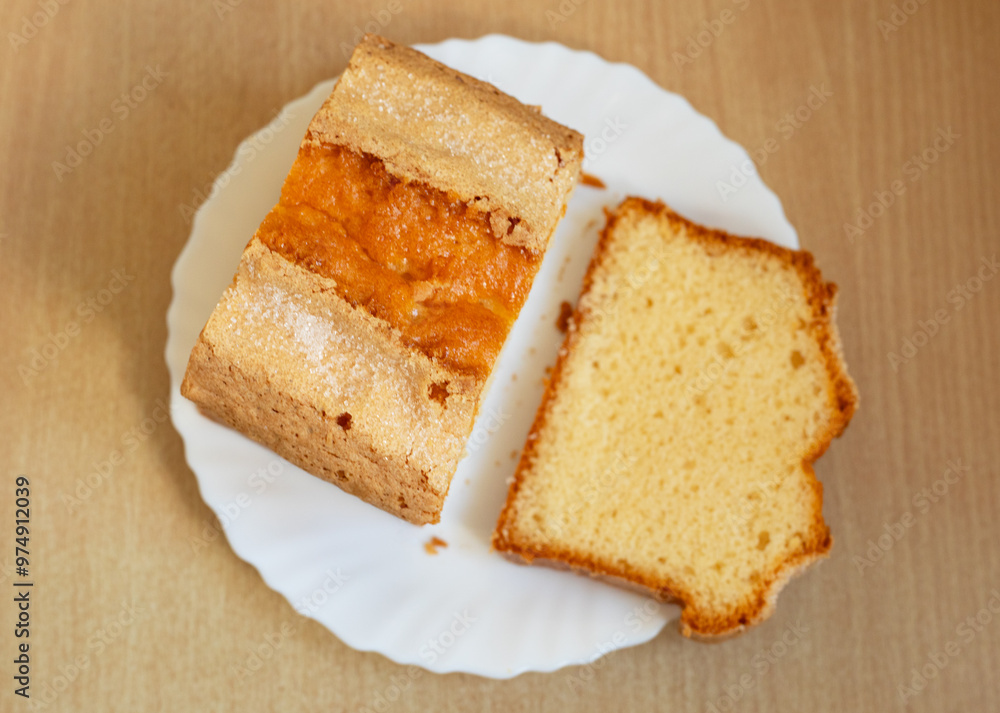 Piece of shortbread cake sprinkled with sugar on white plate. Piece of shortbread cake sprinkled with sugar on white plate.