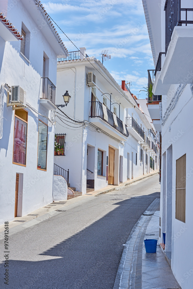 Obraz premium Street, mountain and travel with old city, holiday and adventure with vacation, Frigiliana and Andalusia. Spain, empty and buildings with architecture, outdoor and road with journey, sky and holiday