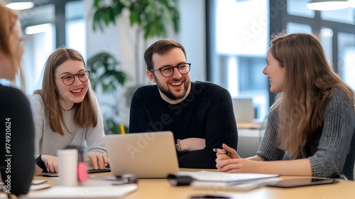 Wallpaper Mural Three Young Professionals Collaborating Around a Laptop at a Table Torontodigital.ca