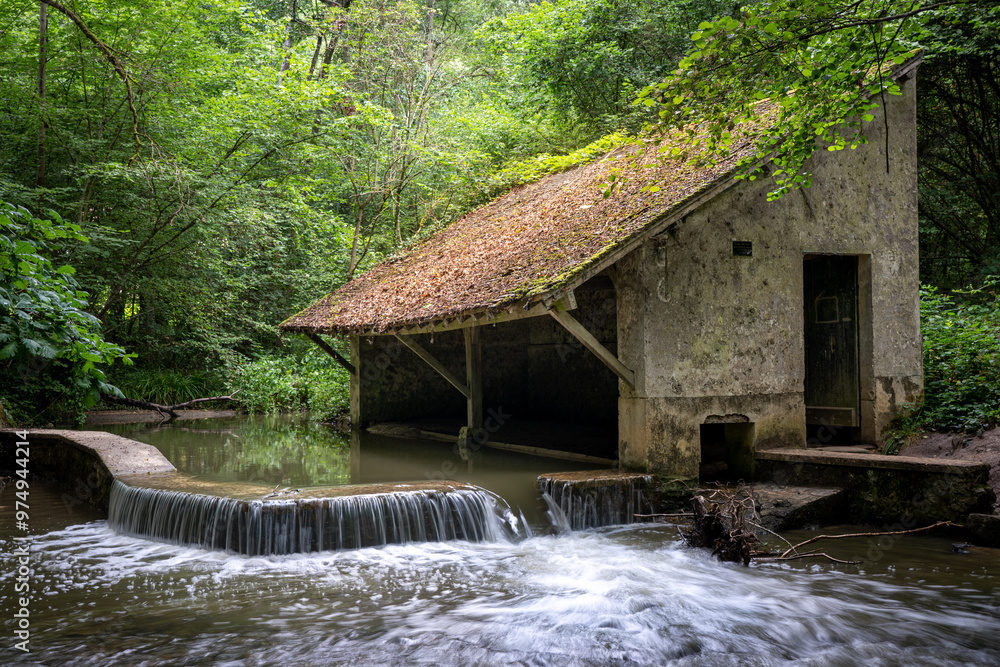Old French lavoir on the Yvette river not far from Paris on a cloudy summer day Old French lavoir on the Yvette river not far from Paris on a cloudy summer day