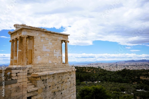 View of the restored Ionic style Temple of Athena Nike, winged goddes of victory on the hill of the Acropolis in Athens, Greece. Sightseeing and vacation in Greece