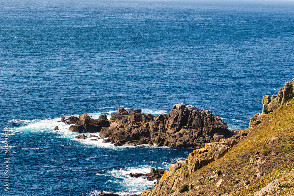 Scenic Coastal View with Rocky Cliffs at Land's End in Cornwall, UK Scenic Coastal View with Rocky Cliffs at Land's End in Cornwall, UK