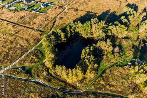 Bird's eye view of a small lake in a field. Lake Kudiska, Zhukovsky District, Kaluga Region, Russia photo