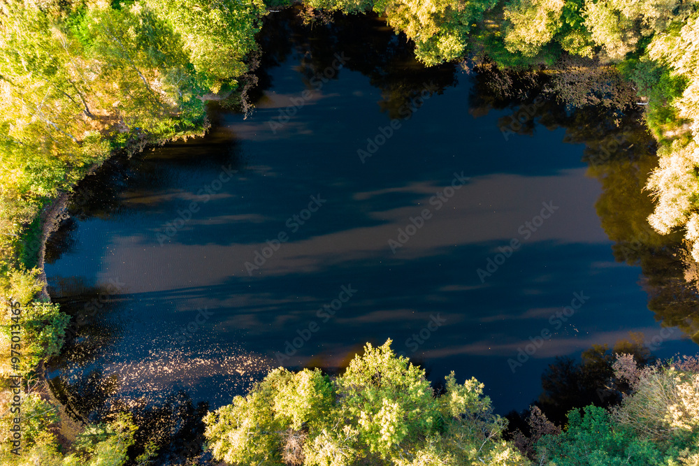 Aerial view of a small lake surrounded by trees. Lake Kudiska, Zhukovsky District, Kaluga Region, Russia