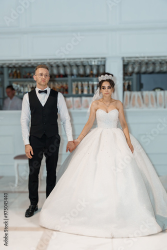 Elegant Wedding Portrait of a Stylish Couple Holding Hands in Chic Ceremony Venue