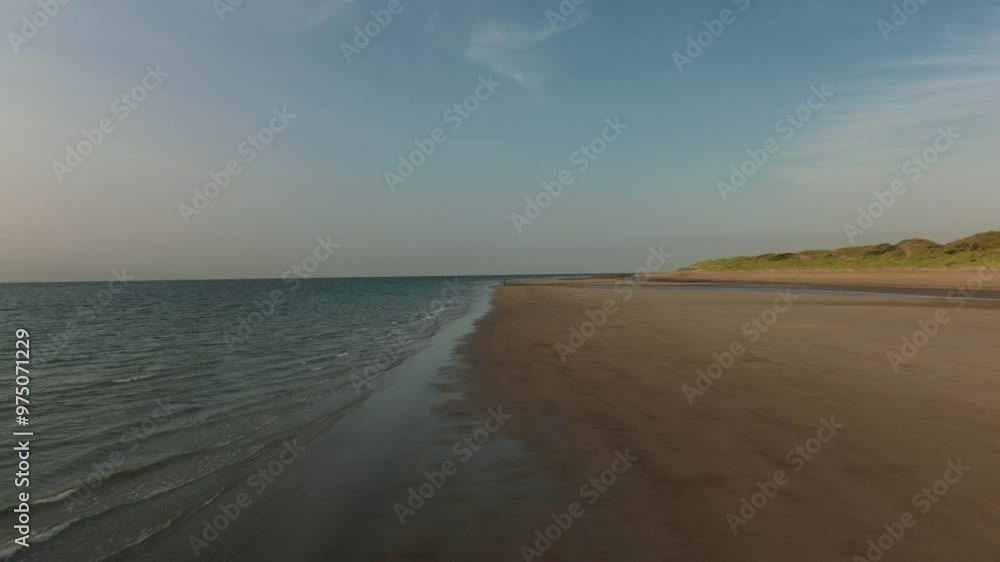 A Beautiful Serene Beach Landscape Featuring Gentle Waves and Lush Coastal Dunes That Enchants A Beautiful Serene Beach Landscape Featuring Gentle Waves and Lush Coastal Dunes That Enchants