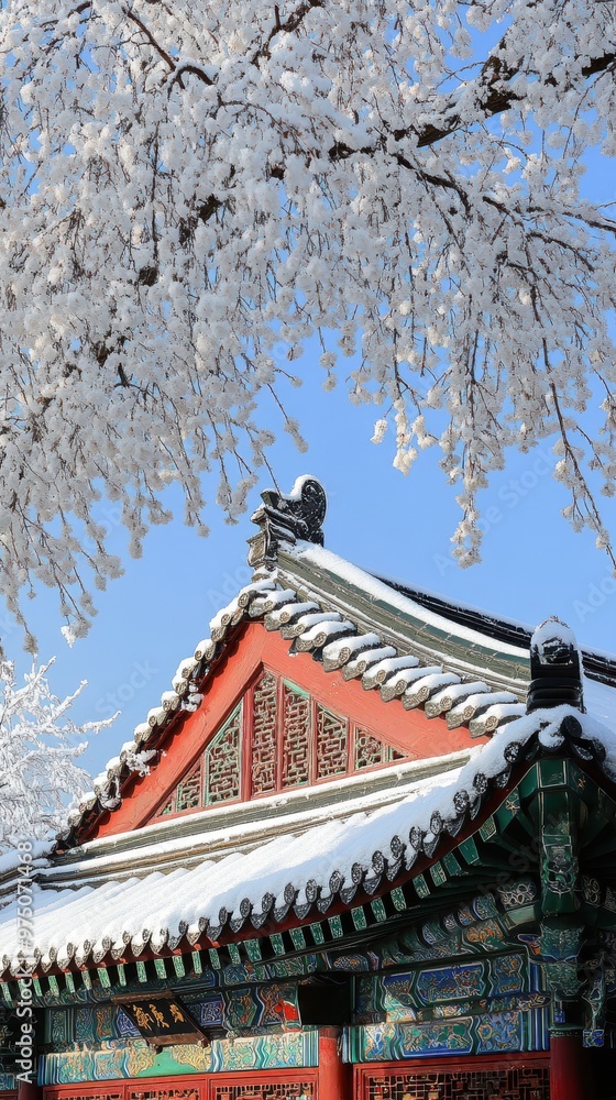 Snow-covered ancient Chinese architecture with traditional roof design under winter branches in serene winter landscape Snow-covered ancient Chinese architecture with traditional roof design under winter branches in serene winter landscape