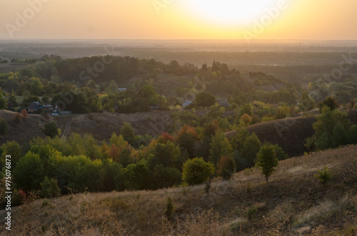 Dawn among the hills in autumn and yellow trees, natural background.