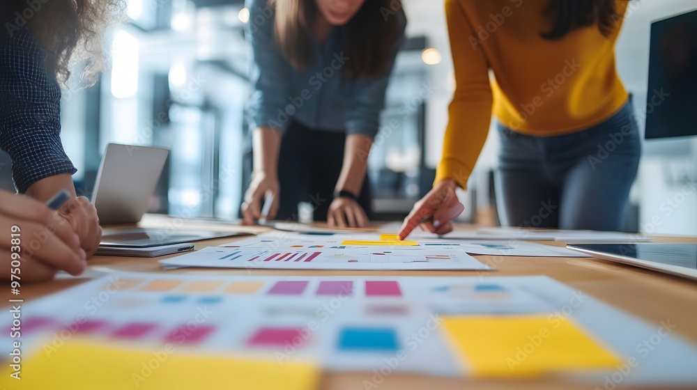Businesspeople Reviewing Documents with Sticky Notes and Charts Businesspeople Reviewing Documents with Sticky Notes and Charts