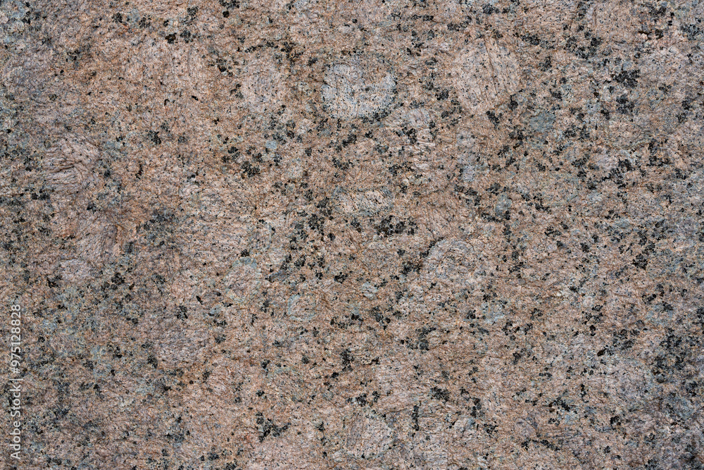 Granite texture. Natural pink granite with a grainy pattern. Stone background. Solid rough surface of rock. Durable construction and decoration material. Close-up. Granite texture. Natural pink granite with a grainy pattern. Stone background. Solid rough surface of rock. Durable construction and decoration material. Close-up.