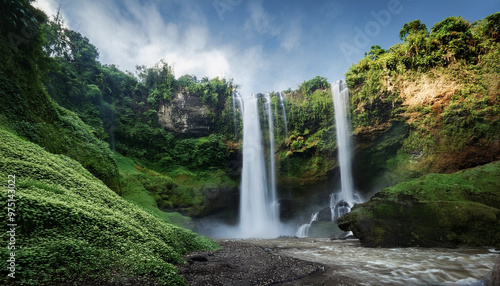 The waterfall is a tall and beautiful waterfall.