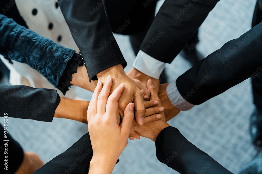 Many happy business people stacking hands together with joy and success. Company employee celebrate after finishing successful work project. Corporate partnership and achievement concept. uds Many happy business people stacking hands together with joy and success. Company employee celebrate after finishing successful work project. Corporate partnership and achievement concept. uds