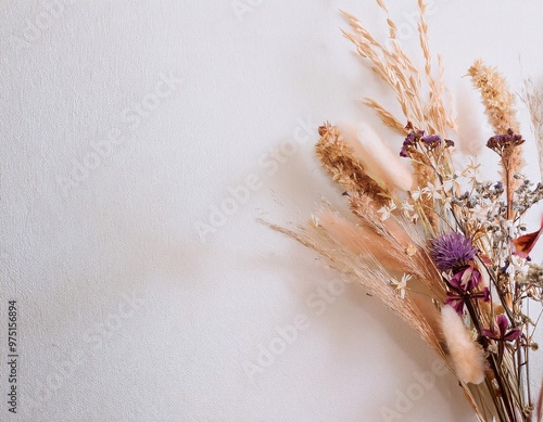 a composition of dried flowers artistically arranged on a minimalist white wall background generative ai photo