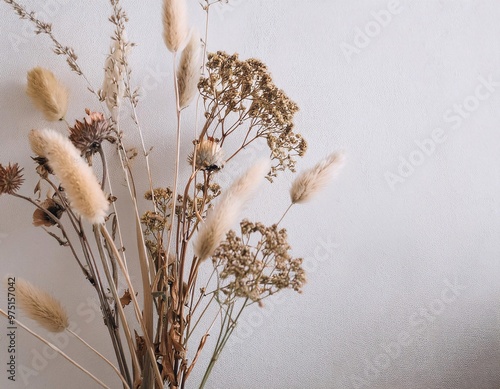 a composition of dried flowers artistically arranged on a minimalist white wall background generative ai photo