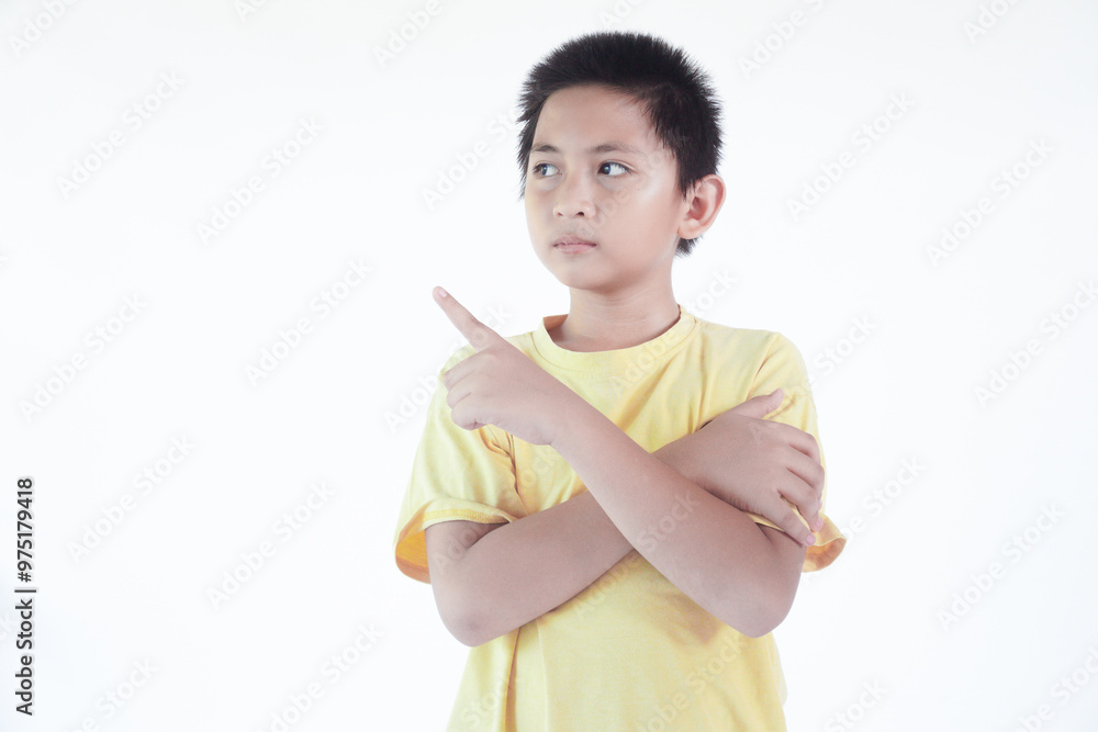 Happy little boy pointing at something on color background Happy little boy pointing at something on color background