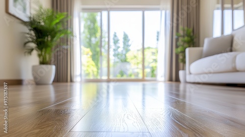 Light wood floor in living room with window and couch