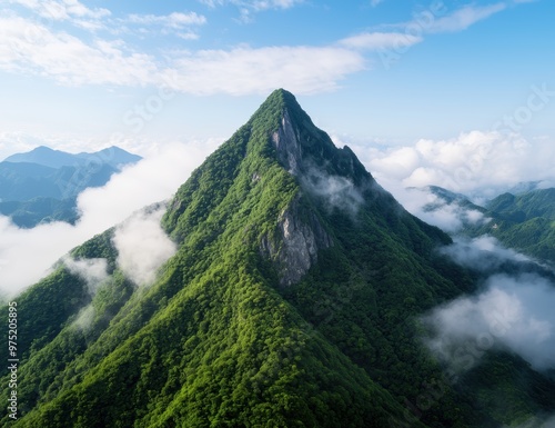 Majestic green mountain peak surrounded by clouds