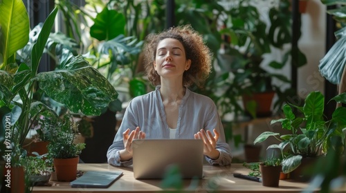 Employee meditating at their desk with plants and natural elements around, wellness at work, stress-free work environment