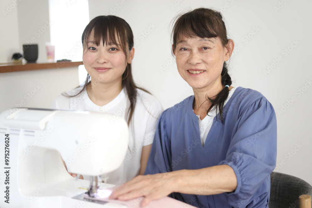 Obraz premium ミシンを使う親子