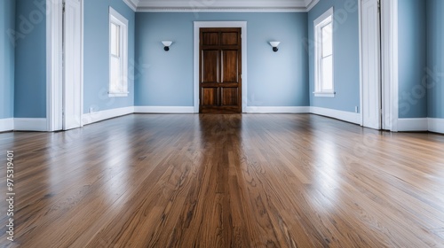 Wallpaper Mural Spacious empty room with wooden flooring, blue walls, and sunlight through windows. Torontodigital.ca