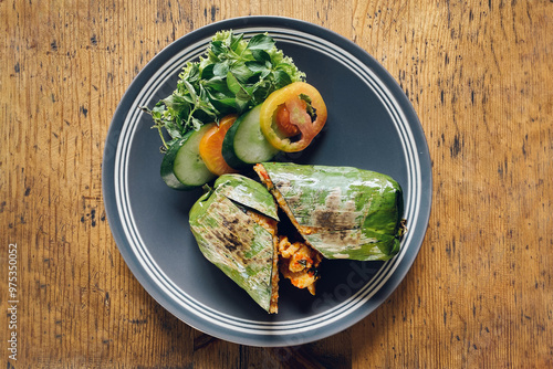 Indonesian food Nasi bakar ayam kemangi or grilled rice with basil chicken photo