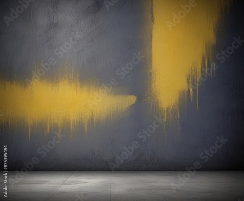 a textured gray wall with yellow paint splatters and drips, creating an abstract and dynamic visual effect.