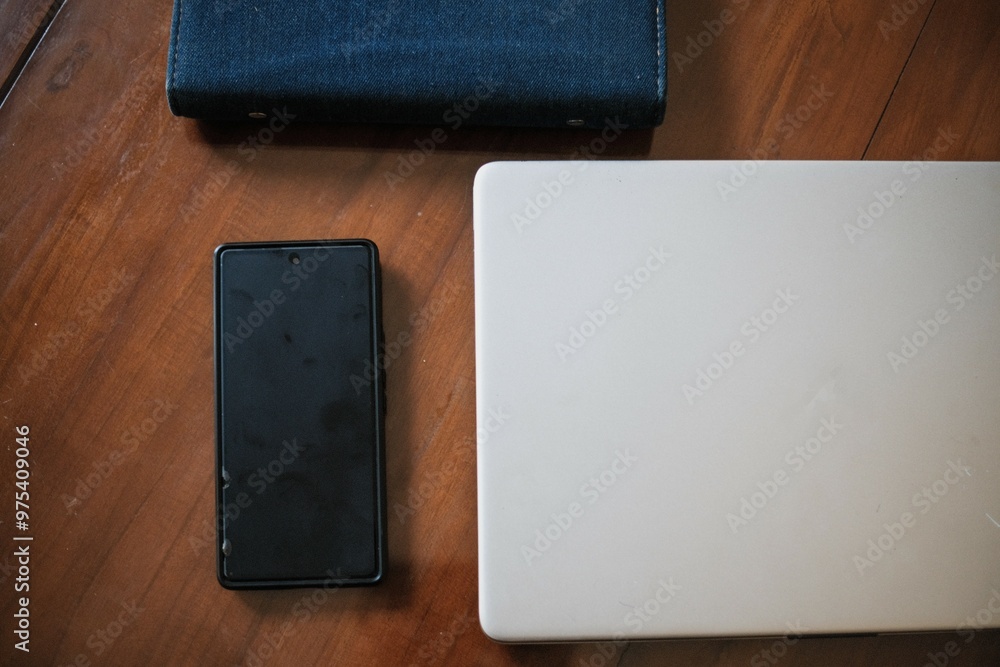 Notepad, laptop, smart phone and on wooden table. View from above with copy space. work place. Notepad, laptop, smart phone and on wooden table. View from above with copy space. work place.