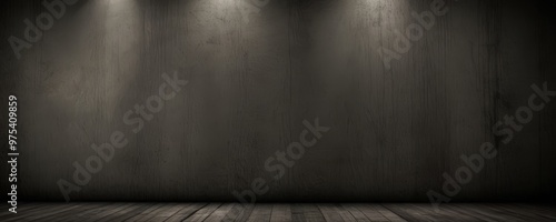 A dark, empty room with a wooden floor and a concrete wall, illuminated by three spotlights.