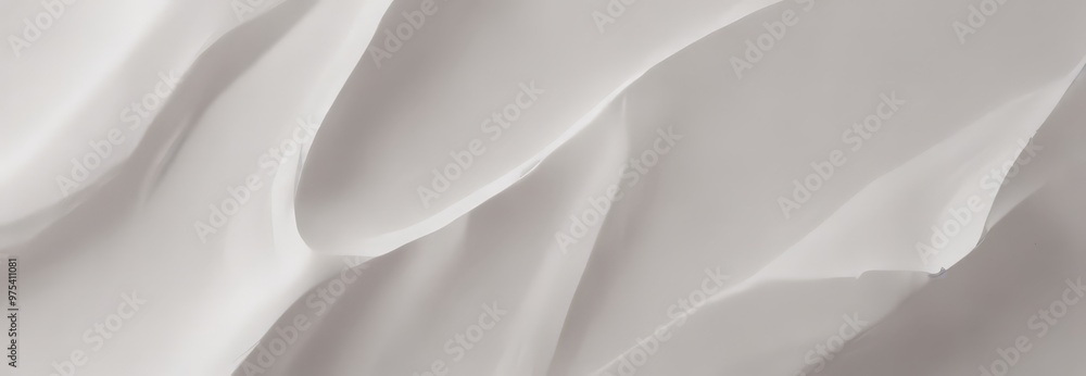 Fototapeta premium a close-up view of a white fabric surface with a subtle texture, featuring curved lines and a smooth, flowing pattern.