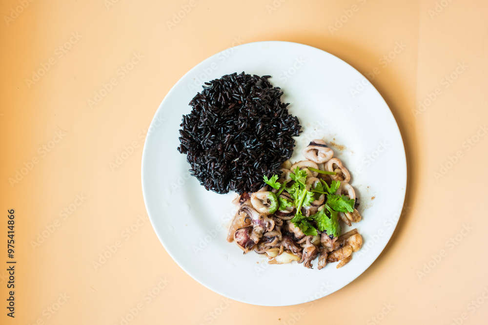 Stir fried squid with garlic served with riceberry rice, healthy homemade food. Stir fried squid with garlic served with riceberry rice, healthy homemade food.
