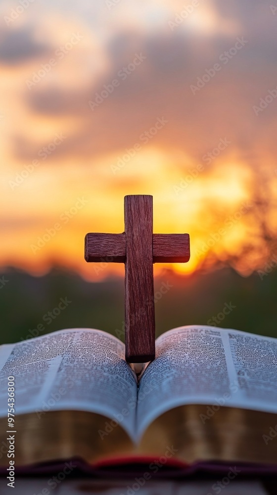 Wooden cross on open bible against sunset background, spiritual serenity concept Wooden cross on open bible against sunset background, spiritual serenity concept