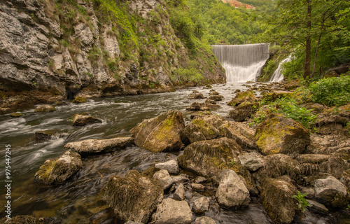 River dam with waterfall in summer