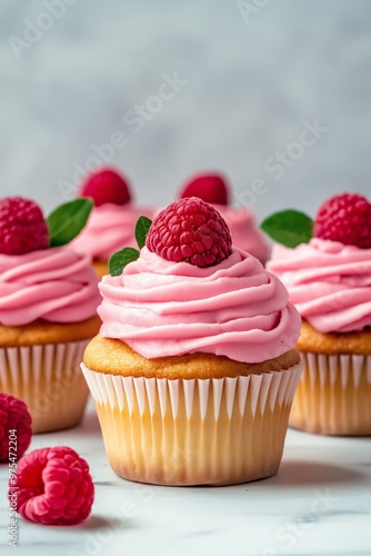 Cupcakes with pink frosting and fresh berry