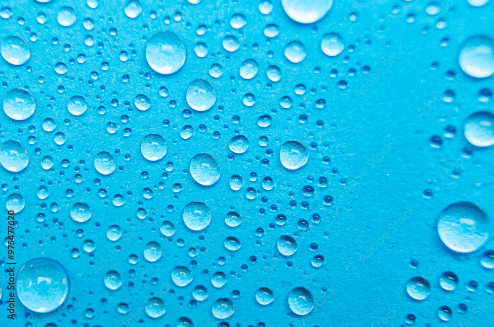 Close up of water droplets on blue cover background. Water droplets concept Close up of water droplets on blue cover background. Water droplets concept