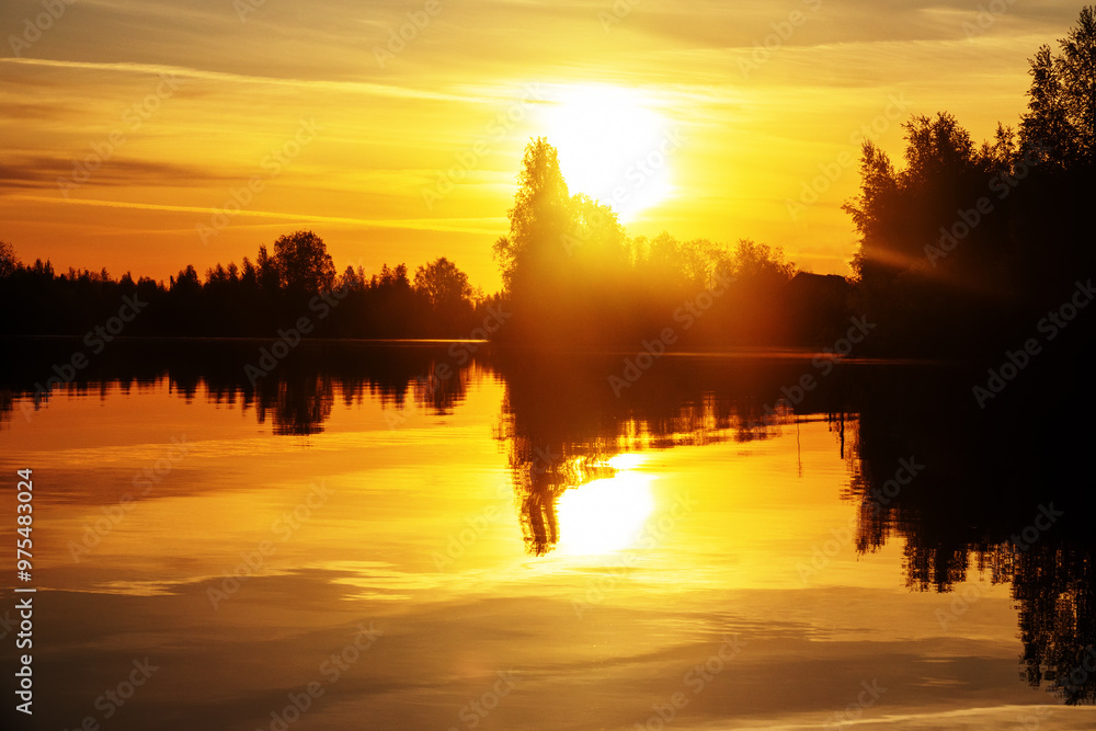 Obraz premium Spring sunrise over the northern smooth water river. Trees with budding foliage, spring clothes the land with verdure